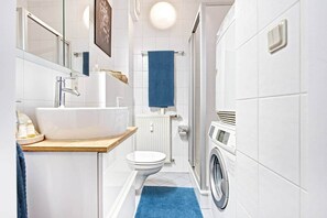 Shower, hair dryer, soap, toilet paper