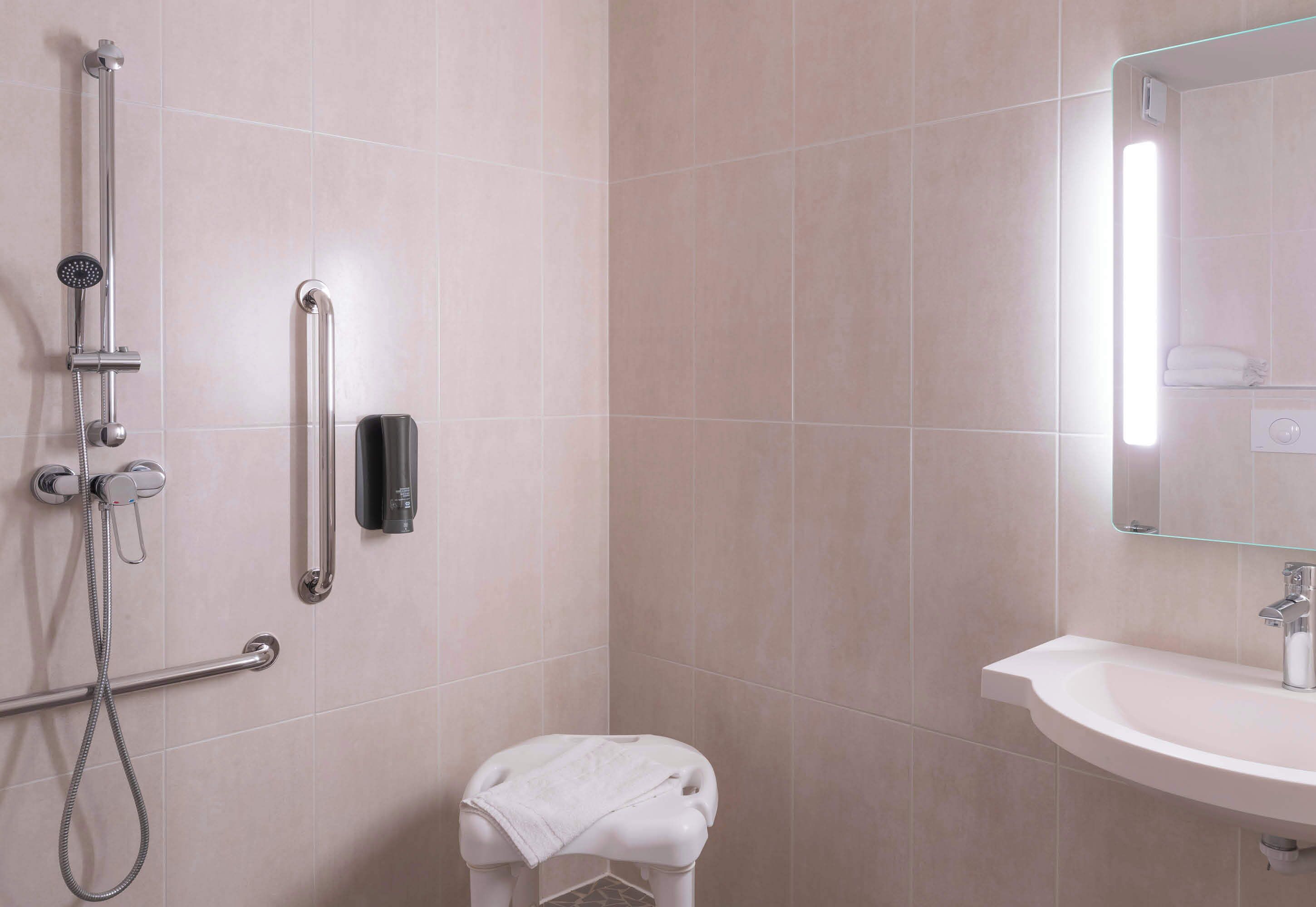 double room, mobility accessible | bathroom | shower, towels, soap, toilet paper
