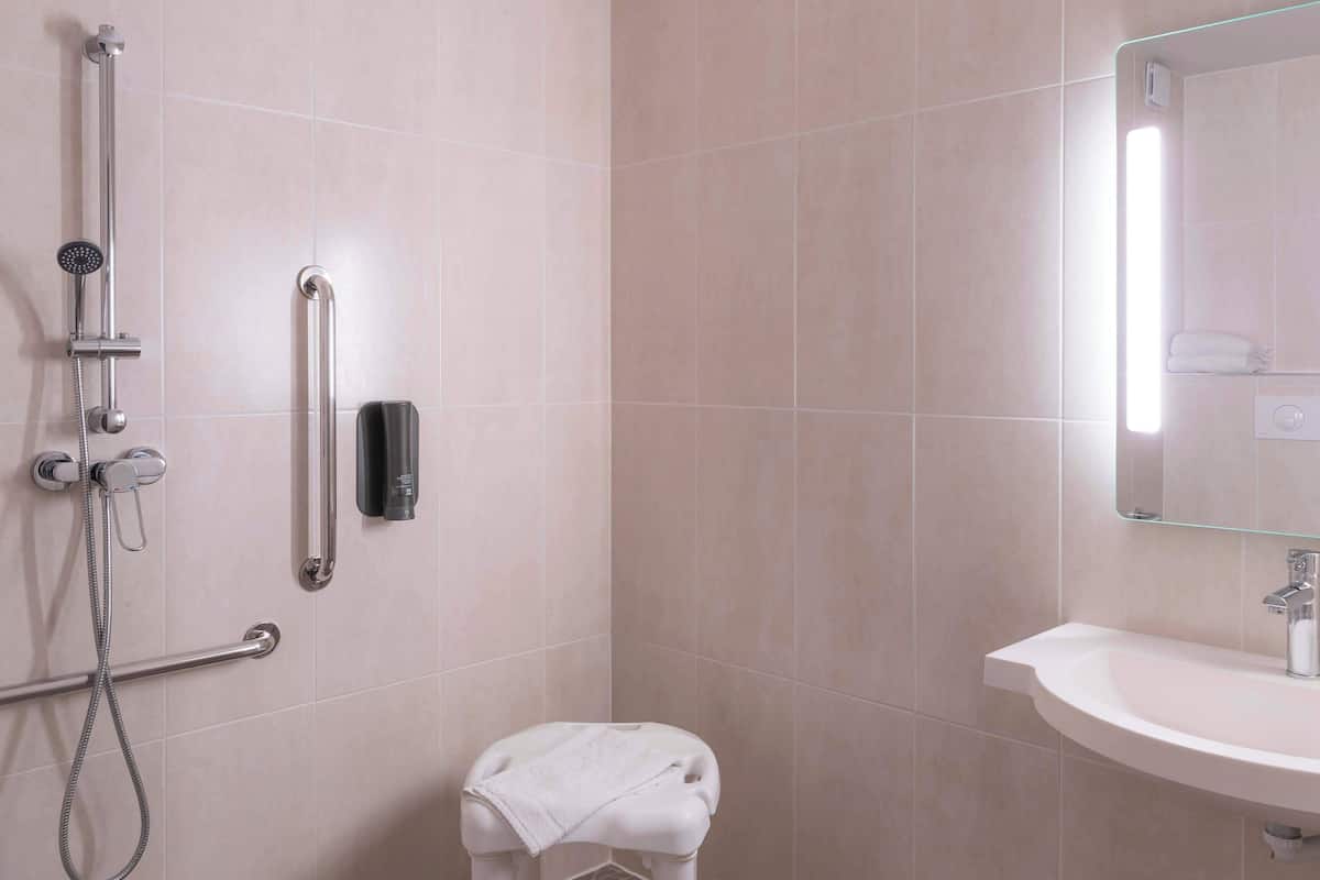 double room, mobility accessible | bathroom | shower, towels, soap, toilet paper