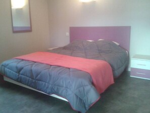 A bedroom with a bed, a bedside table, and a nightstand. - HOLIDAY VILLAGE OF LAKE MENET / FACING THE LAKE OF 14 HECTARES (Menet)