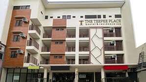 A multi-story building with balconies, air conditioning units, and a sign for 'The Tepee Place hostel & residence inn.' - Super OYO 832 The Teepee Place Hostel & Residence Inn (Cebu City)