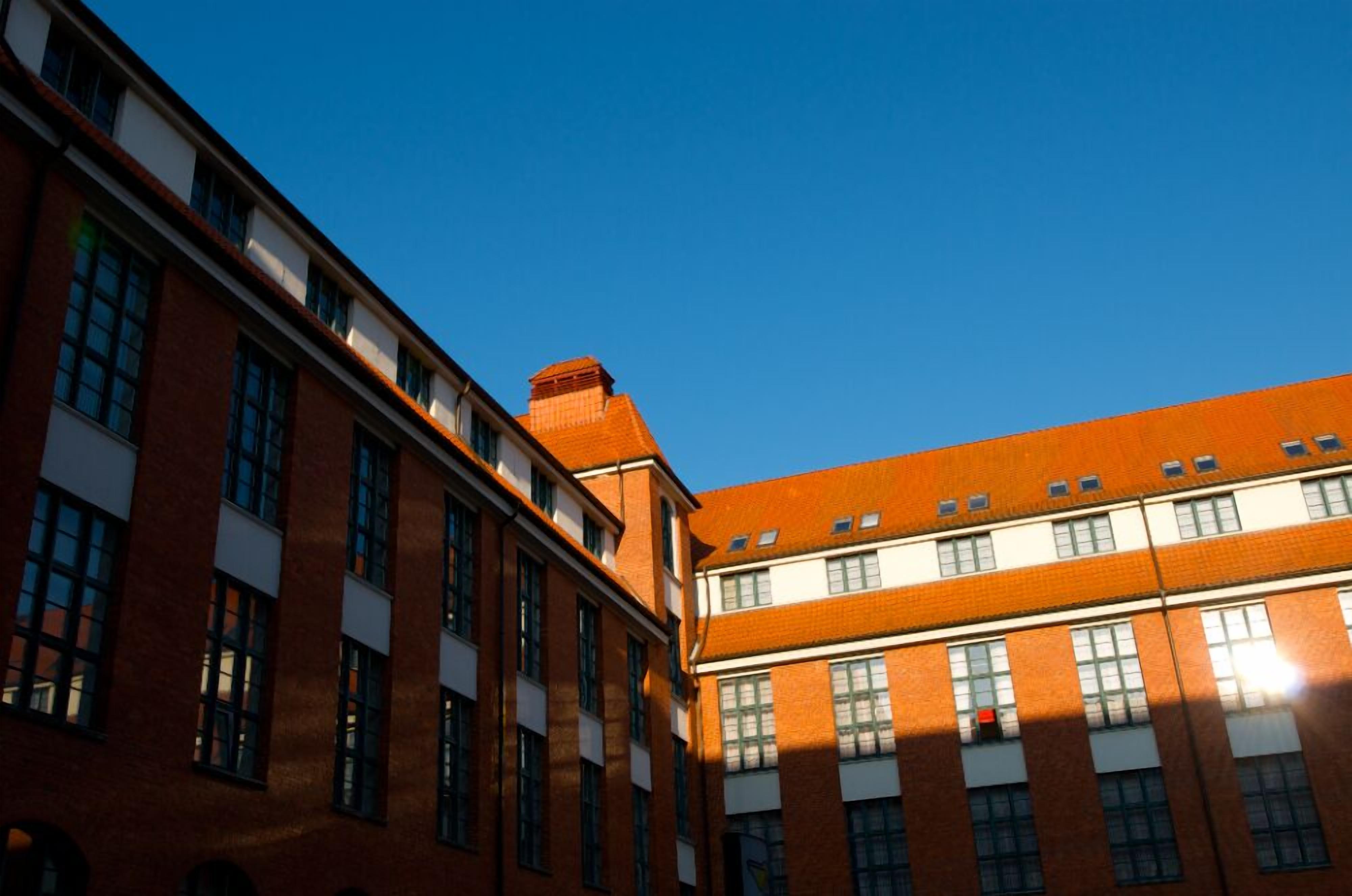 A multi-story building with a brick facade and large windows.
