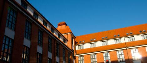 A multi-story building with a brick facade and large windows.