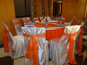 Conference room with a round table and comfortable seating for meetings.