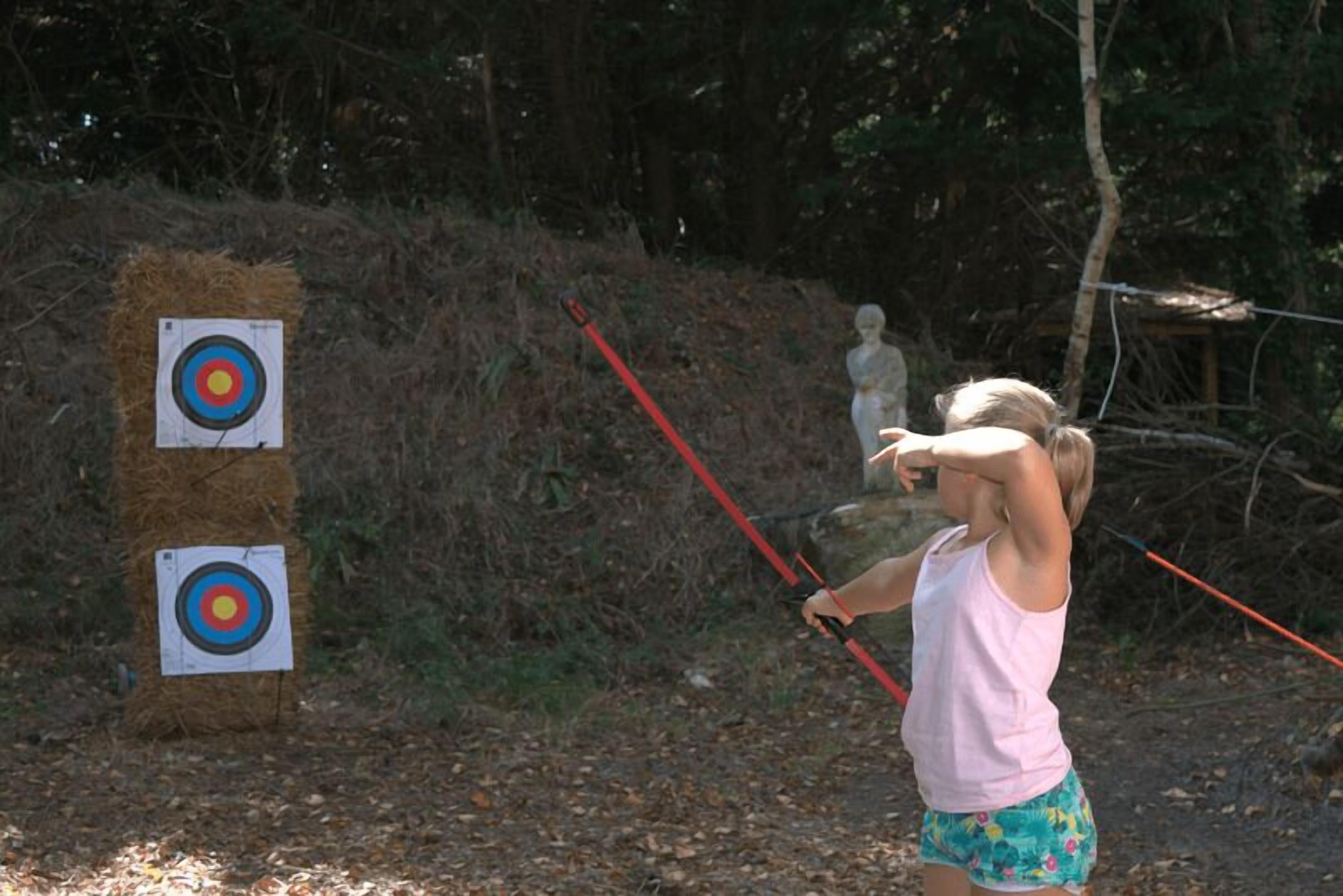 A person aiming an arrow at a target.