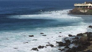 A coastal view with a building on a cliff overlooking the ocean. - Gorgeous Ocean Front Condo -Rosarito Beach -VIEWS! (Rosarito)