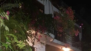 A white car parked on a cobblestone driveway at night. - Riverston mountain view bungalow (Matale)