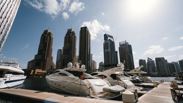 A marina with yachts docked, surrounded by tall buildings. - DM1 Comfortable Apartment in Dubai Marina (Dubai)