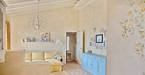 A cozy living room with a checkered sofa, a chandelier, and a blue cabinet. - Breathtaking view of Lake Garda (Padenghe Sul Garda)