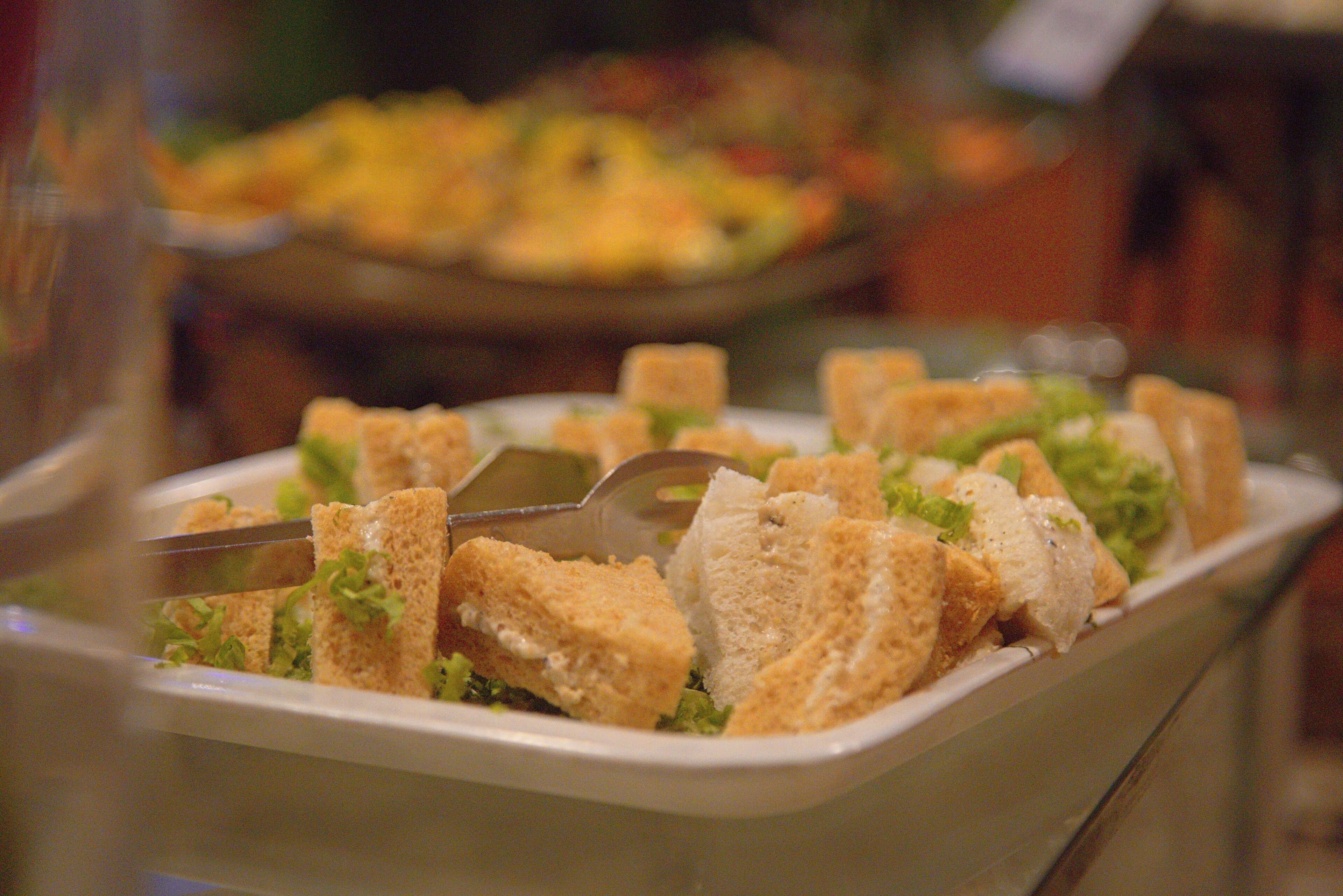 A buffet with various dishes, including a salad and bread.