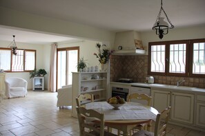 Enjoy meals in the kitchen with a large island, dining area, and round table.