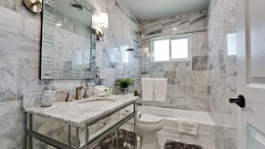 Bathtub, hair dryer, towels, soap