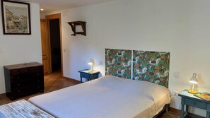 A bedroom with a bed, dresser, nightstands, and a painting on the wall. - Country house with a lot of character in Corneilla del Vercol (CORNEILLA DEL VERCOL)