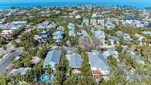 A coastal residential area with houses, a swimming pool, and a view of the ocean. - Pineapple Cottage, tropical oasis pool/spa (Anna Maria)