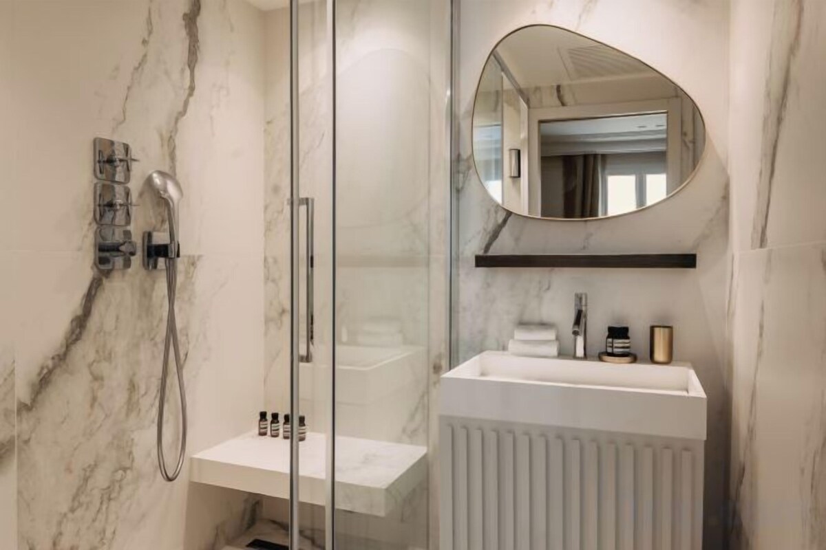Bathroom | Shower, rainfall showerhead, hair dryer, towels