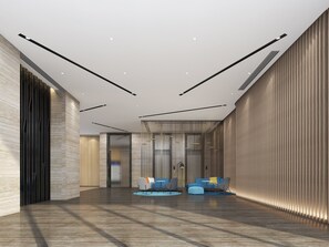 A modern lobby with a high ceiling, recessed lighting, and a seating area with sofas and chairs. - Holiday Inn Express Urumqi Station by IHG (Ürümqi)