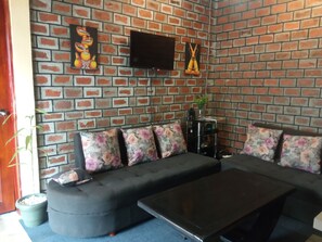 TV, fireplace, table football, books - Plastic Bottles House (Entebbe)