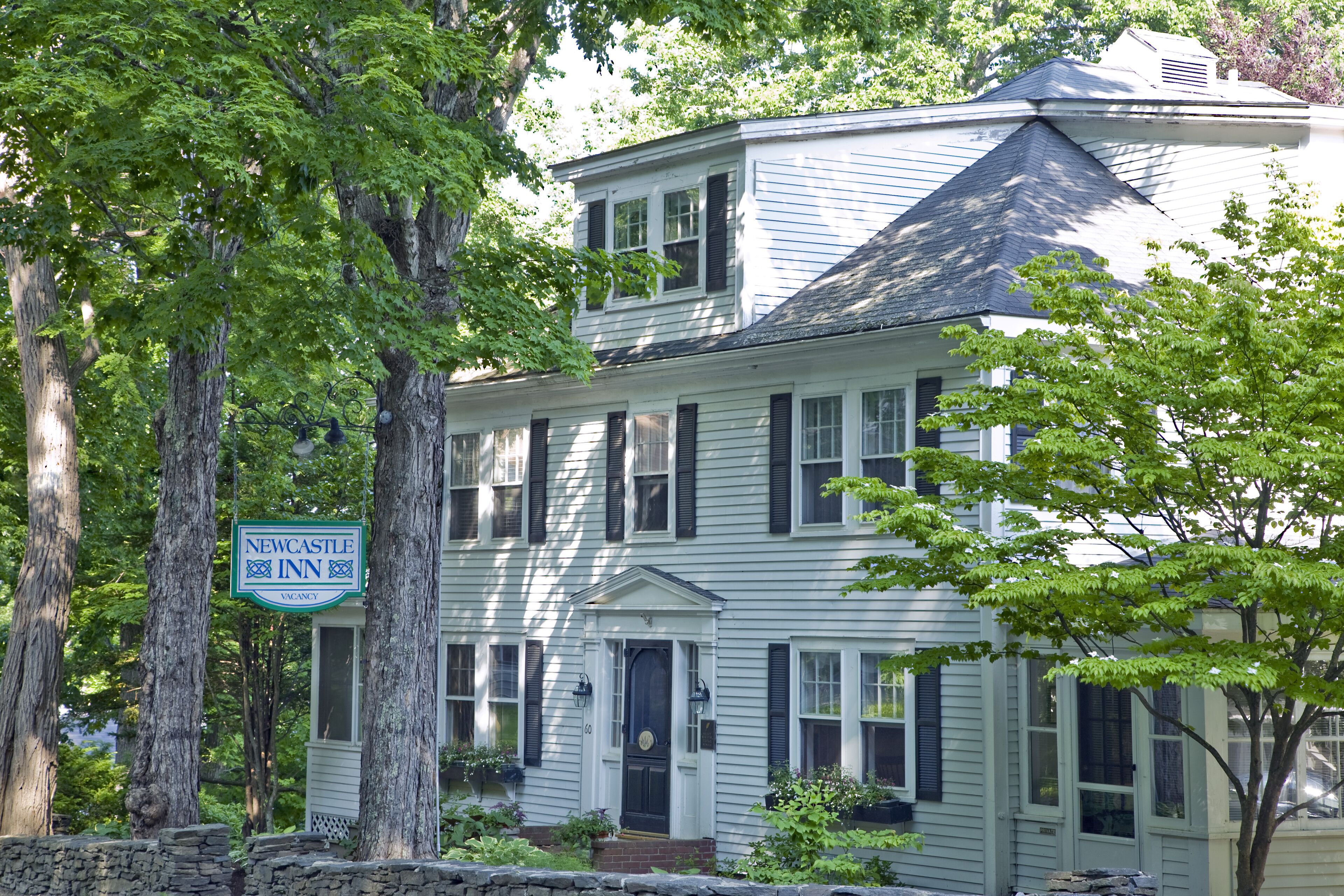 A two-story building with a sign indicating it is a Newcastle Inn.