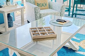 Relax in this stylish space with a light-colored sofa, blue chair, and patterned rug.