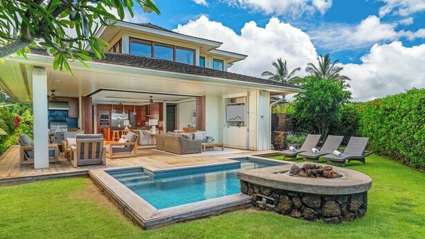 Una casa moderna con piscina, mobiliario de exterior y un patio cubierto.
