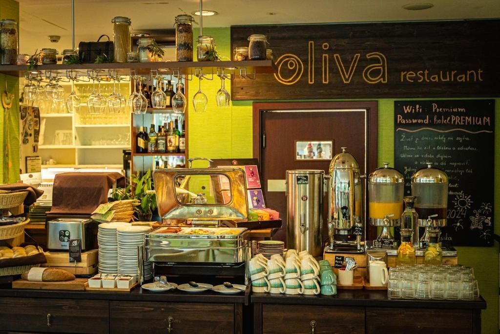 A restaurant counter with a coffee machine, glassware, and various food items.