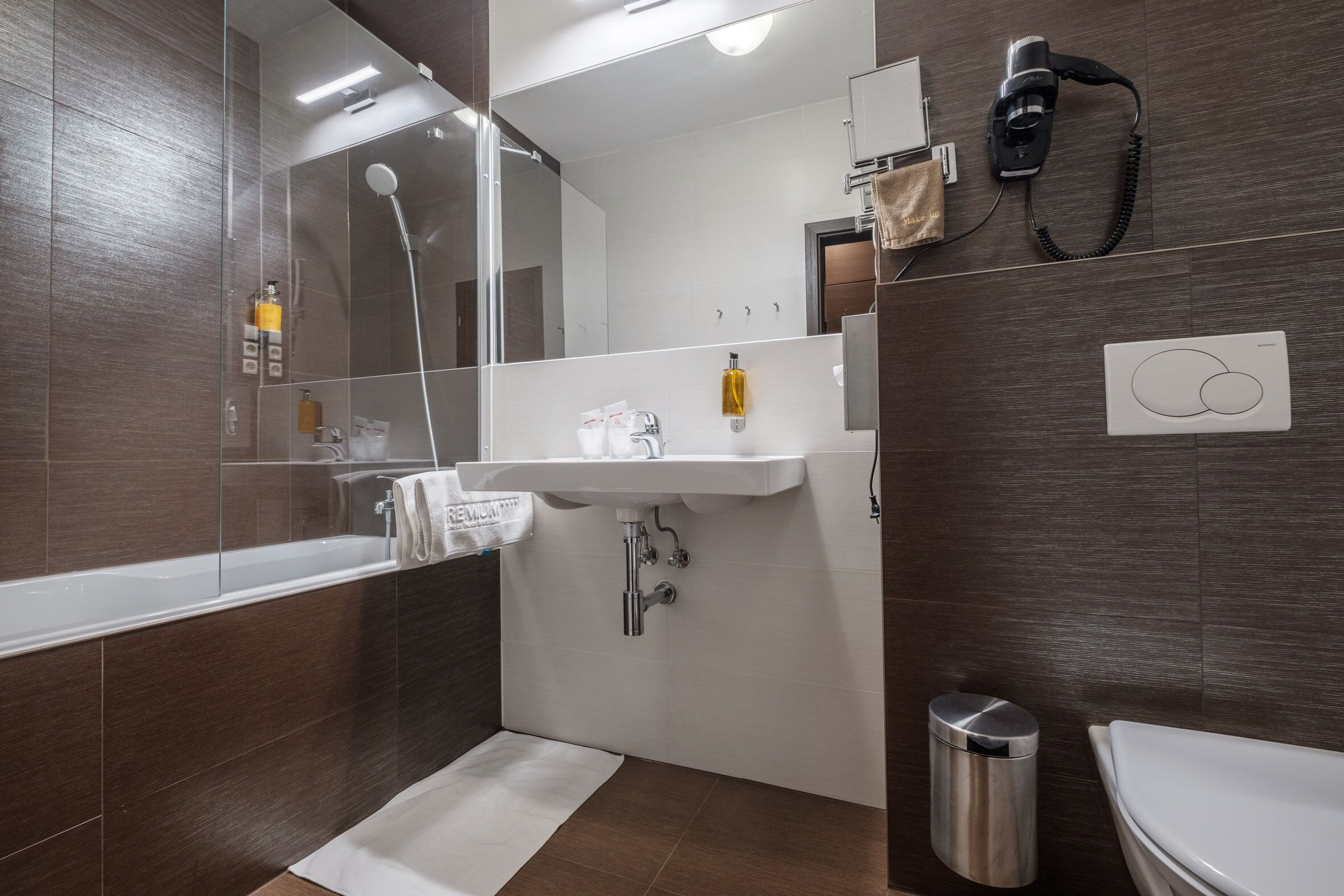 bathtub, eco-friendly toiletries, hair dryer, towels