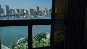A cityscape with a river, buildings, and a bridge. - Nile sky hotel and suites (Cairo)