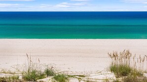 A beach with clear turquoise water and a sandy shore. - 1st Floor ~ Pet Friendly ~ Fall Specials! Free Beach Chair Service! (Panama City Beach)