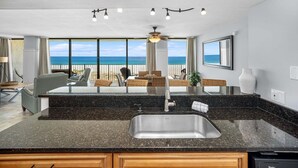 A kitchen with a large island, a sink, and a view of the ocean. - 1st Floor ~ Pet Friendly ~ Fall Specials! Free Beach Chair Service! (Panama City Beach)