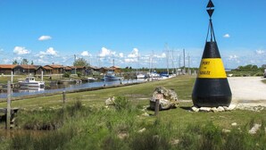 A coastal scene with a buoy marked "PORT DE GOULÉE" and a marina with boats. - Lovely apartment in villa for 5 people with WIFI and TV (Jau-dignac-et-loirac)