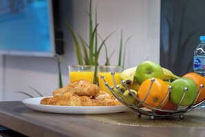 A breakfast setting with croissants, a fruit bowl, and a glass of orange juice. - London Street, Andover, Hampshire, SP102NU, United Kingdom (Andover)