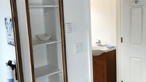 A room with a white wardrobe, a white door, and a wooden floor. - Steps from the ocean in the heart of Hampton Beach! (Hampton)
