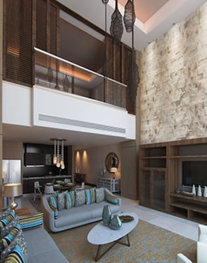 Relax in a spacious living area with a sofa, armchairs, and TV.
