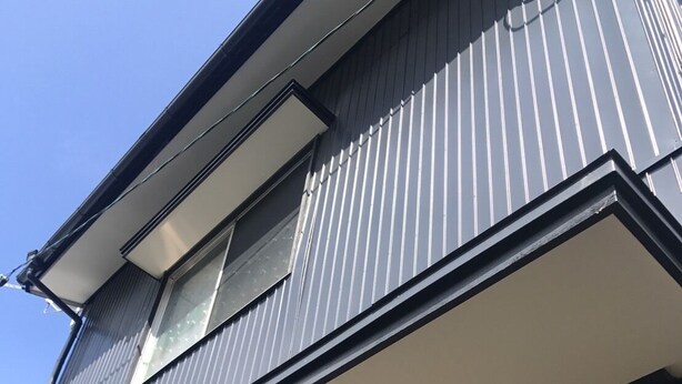 A multi-story building with a modern architectural design, featuring a prominent balcony on the second floor and a large window on the third floor. - Local Tenjin House (Fukuoka)