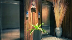 A modern elevator interior with wooden paneling and a digital display. - Yunfan Hotel (Phnom Penh)