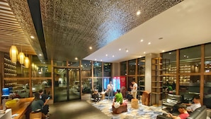 A modern lobby with seating areas, a reception desk, and large windows. - Yunfan Hotel (Phnom Penh)