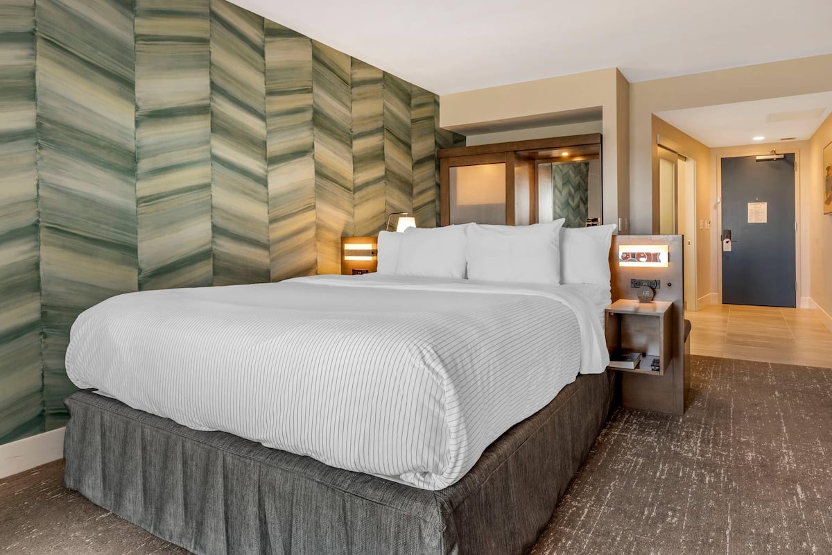 Premium bedding, desk, laptop workspace, blackout drapes