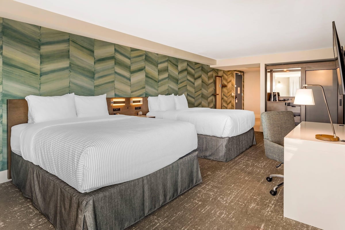 Premium bedding, desk, laptop workspace, blackout drapes