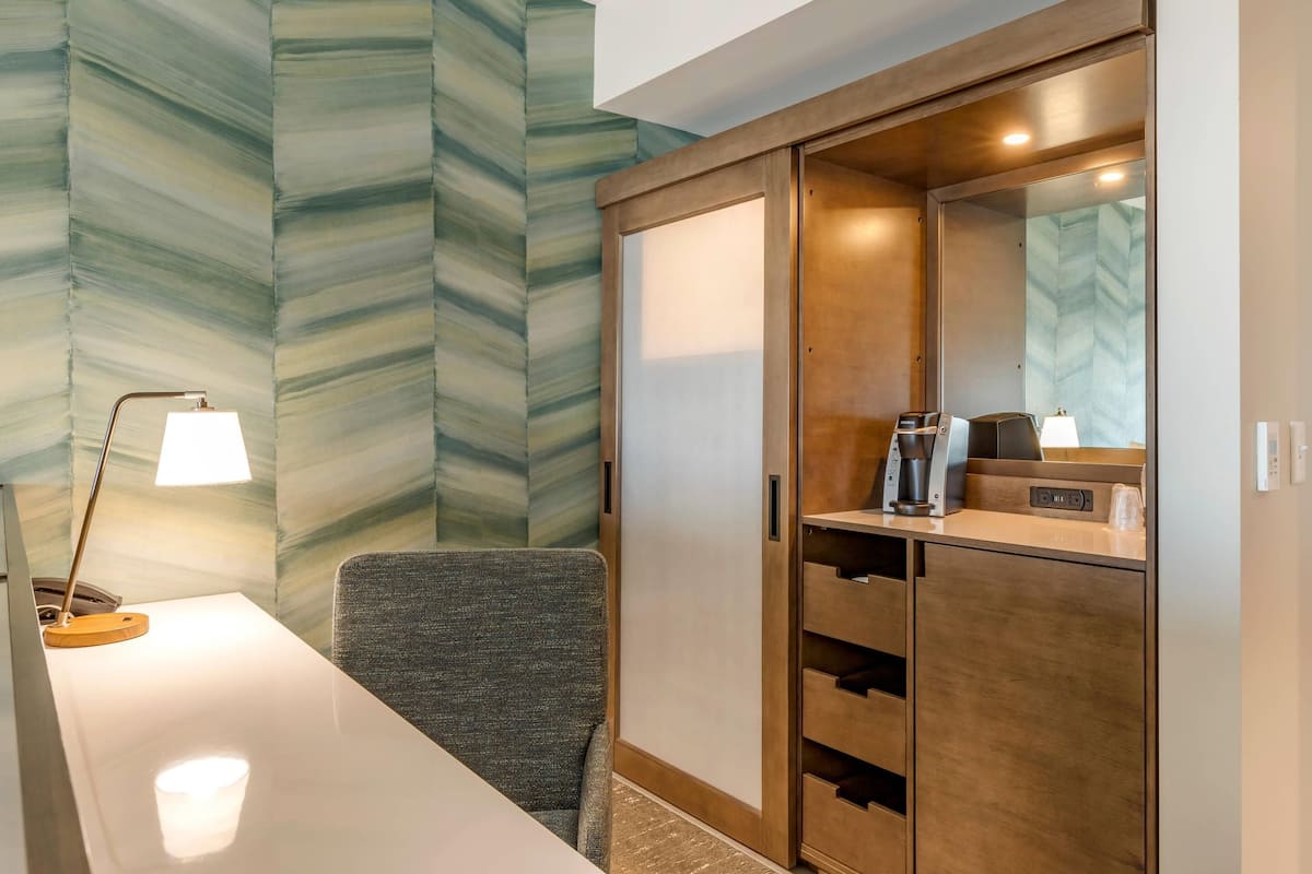 Premium bedding, desk, laptop workspace, blackout drapes