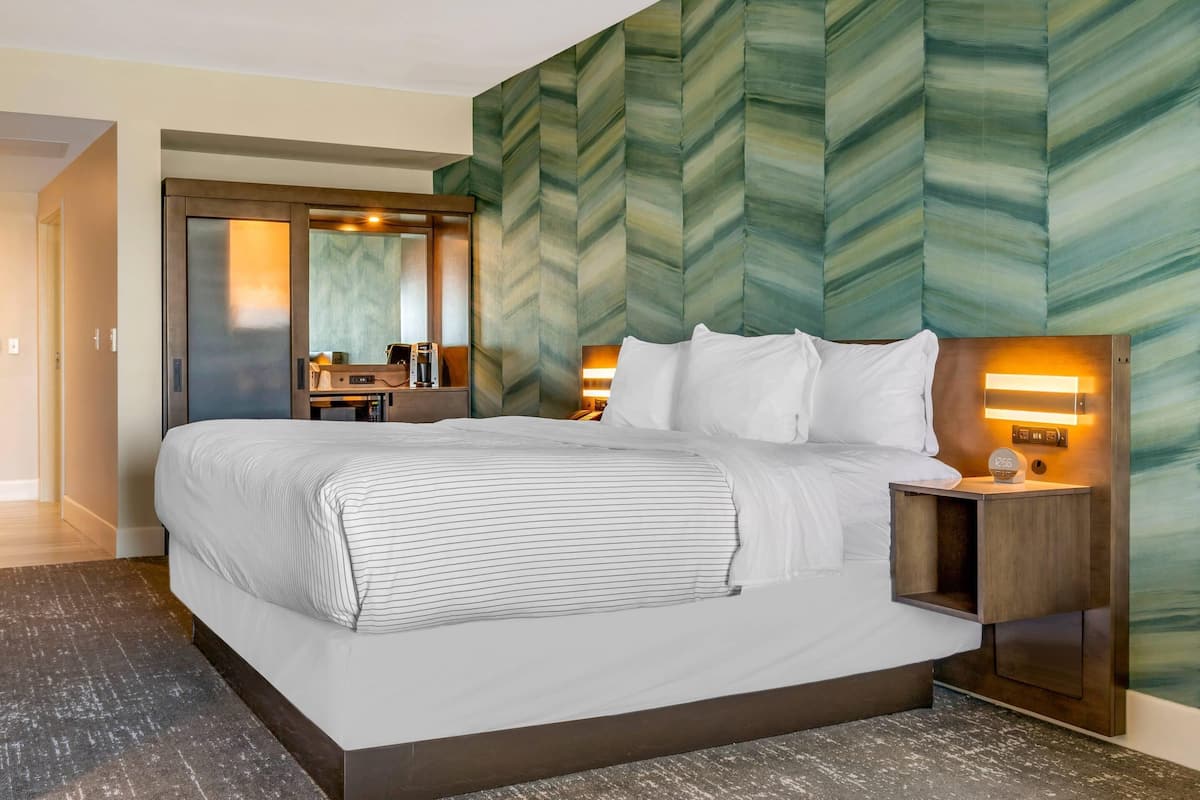 Premium bedding, desk, laptop workspace, blackout drapes