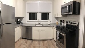 A modern kitchen with a stainless steel refrigerator, a dishwasher, a microwave, and an oven. - Fresh space near Mayo Clinic and downtown (Rochester)