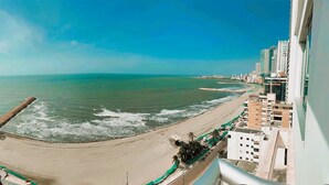 A coastal cityscape with a beach, buildings, and a clear sky. - Ocean Front Apartment in Bocagrande (Cartagena)