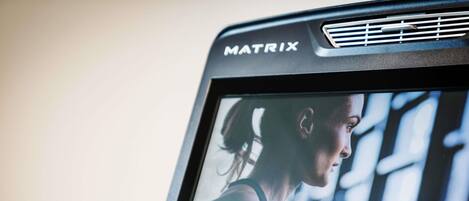 A Matrix branded device with a screen displaying a person exercising.