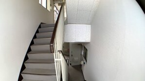 A spiral staircase with a handrail and a light fixture at the top. - Big Stone Tsukuda 303 (Aomori)