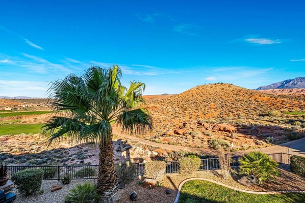 A desert landscape with a palm tree, rocky hills, and a clear sky. - 4098 Coral Ridge, The 19th Hole in Coral Ridge, near golf course, firepit, heated pool, SLP 12 (Washington)