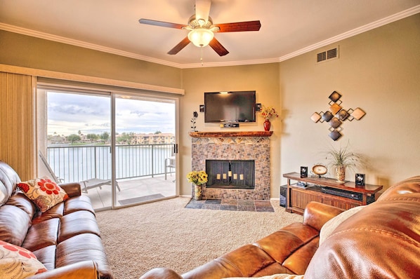 Relax in this stylish living room with a fireplace, flat-screen TV, and comfortable leather sofas.