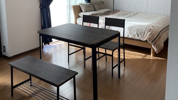 A small, clean room with a bed, a table, and a bench. - G&R House 101 (Tokyo)