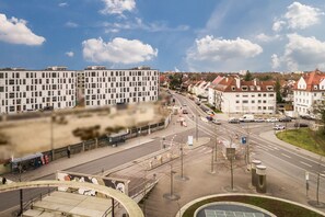 A modern urban street with buildings, a roundabout, and a clear sky. - Hotel Ludwig (Munich)