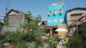 A building with a blue facade and a sign reading "Coromoto".