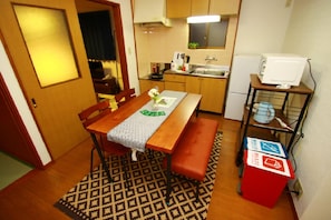 A compact kitchen with wooden cabinets, a microwave, and a small sink.